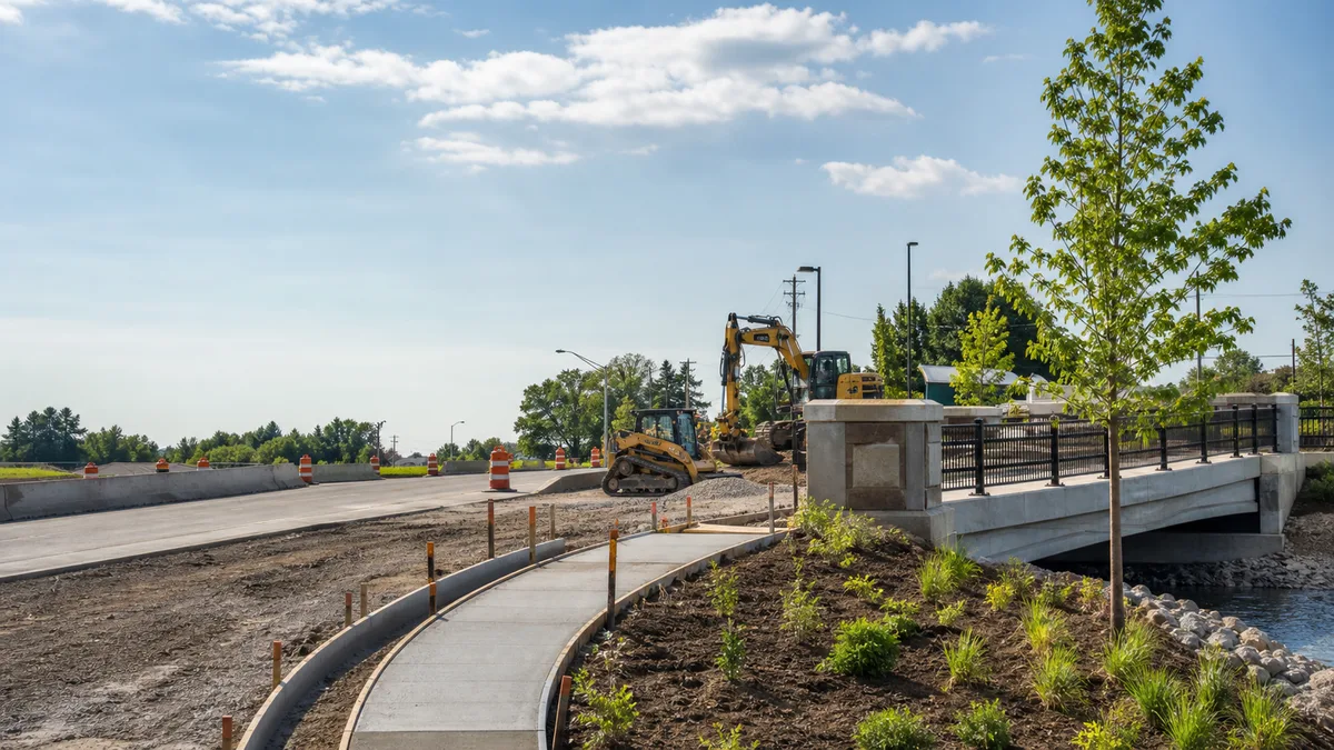 Construction worksite with concrete sidewalk forms, landscaping, infrastructure support, and general contracting coordination